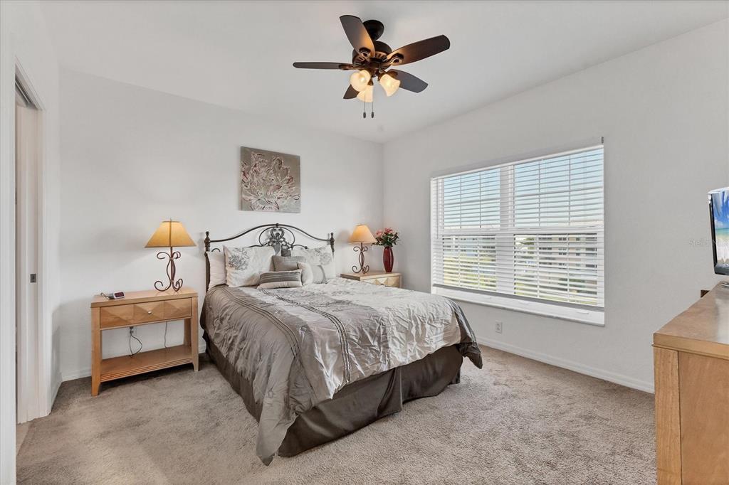 8411 Placida Road, Unit 404 Placida, FL 33946 - Photo 20 of 54 a bedroom with a bed and a chandelier