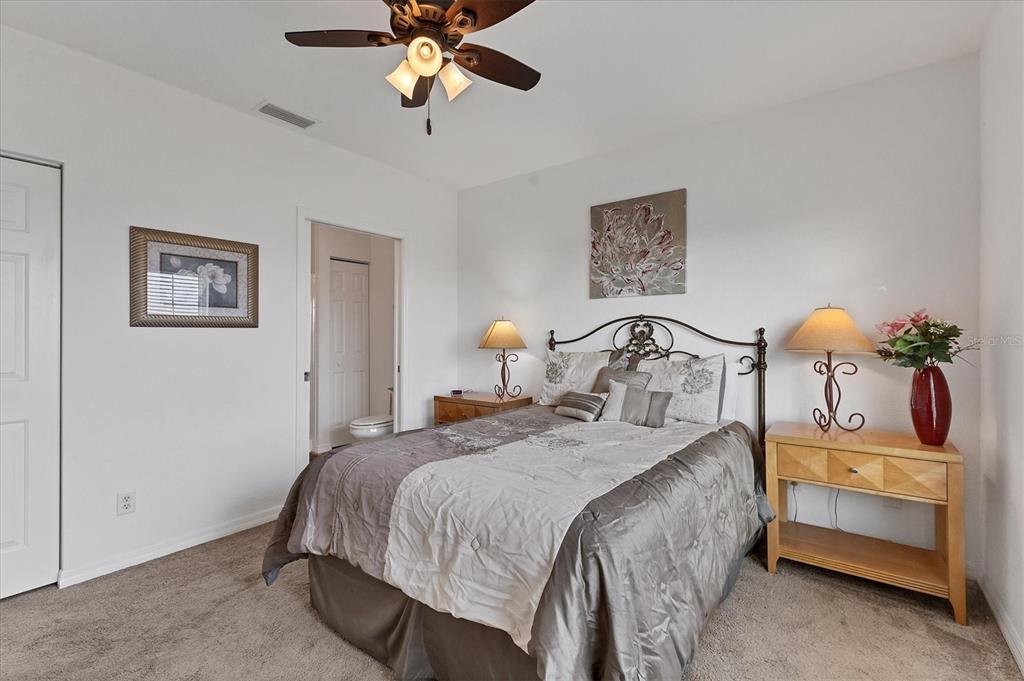 8411 Placida Road, Unit 404 Placida, FL 33946 - Photo 22 of 54 a bedroom with a bed and a chandelier
