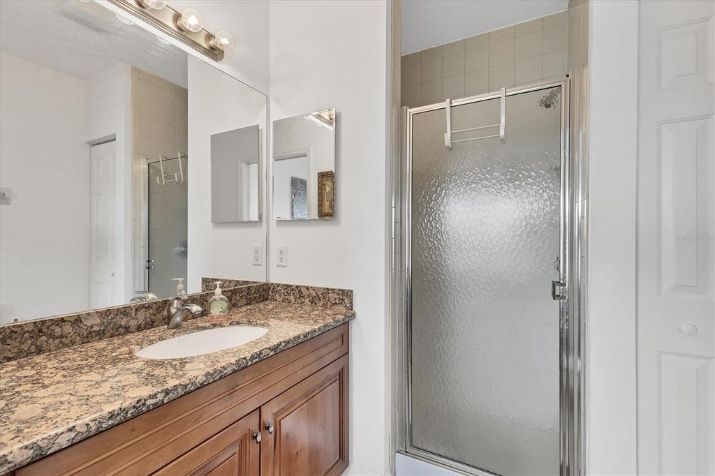 8411 Placida Road, Unit 404 Placida, FL 33946 - Photo 23 of 54 a bathroom with a granite countertop sink and a mirror
