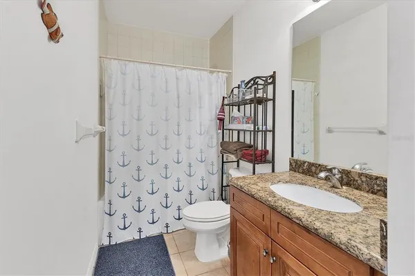 a bathroom with a toilet a sink and a shower