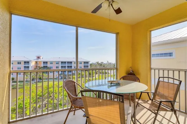 a view of a balcony with table and chairs