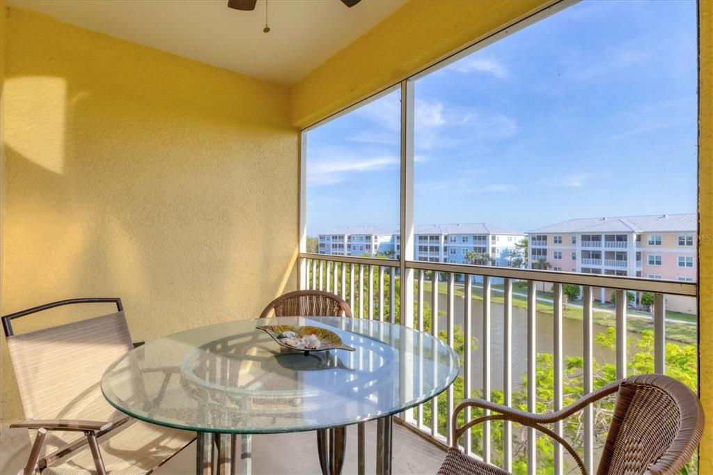 8411 Placida Road, Unit 404 Placida, FL 33946 - Photo 29 of 54 a view of a balcony with table and chairs