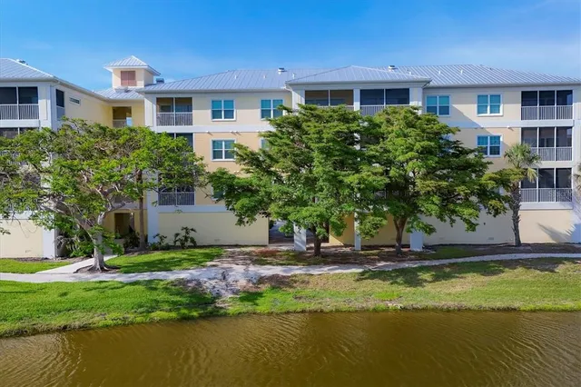 a front view of a house with a yard and lake view