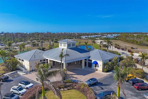 an aerial view of residential houses with outdoor space and lakeside