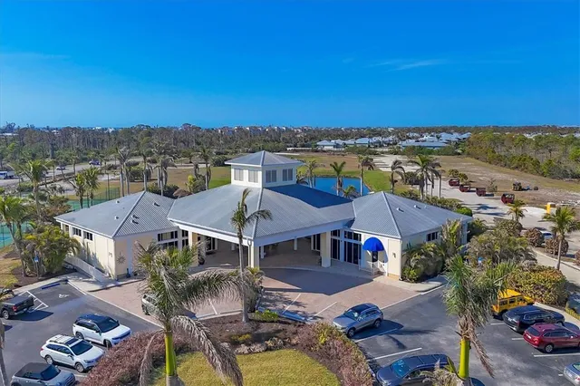 an aerial view of residential houses with outdoor space and lakeside