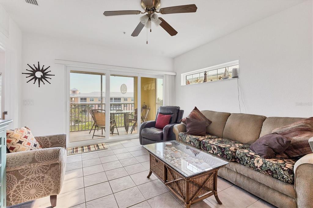 8411 Placida Road, Unit 404 Placida, FL 33946 - Photo 10 of 54 a living room with furniture and a large window