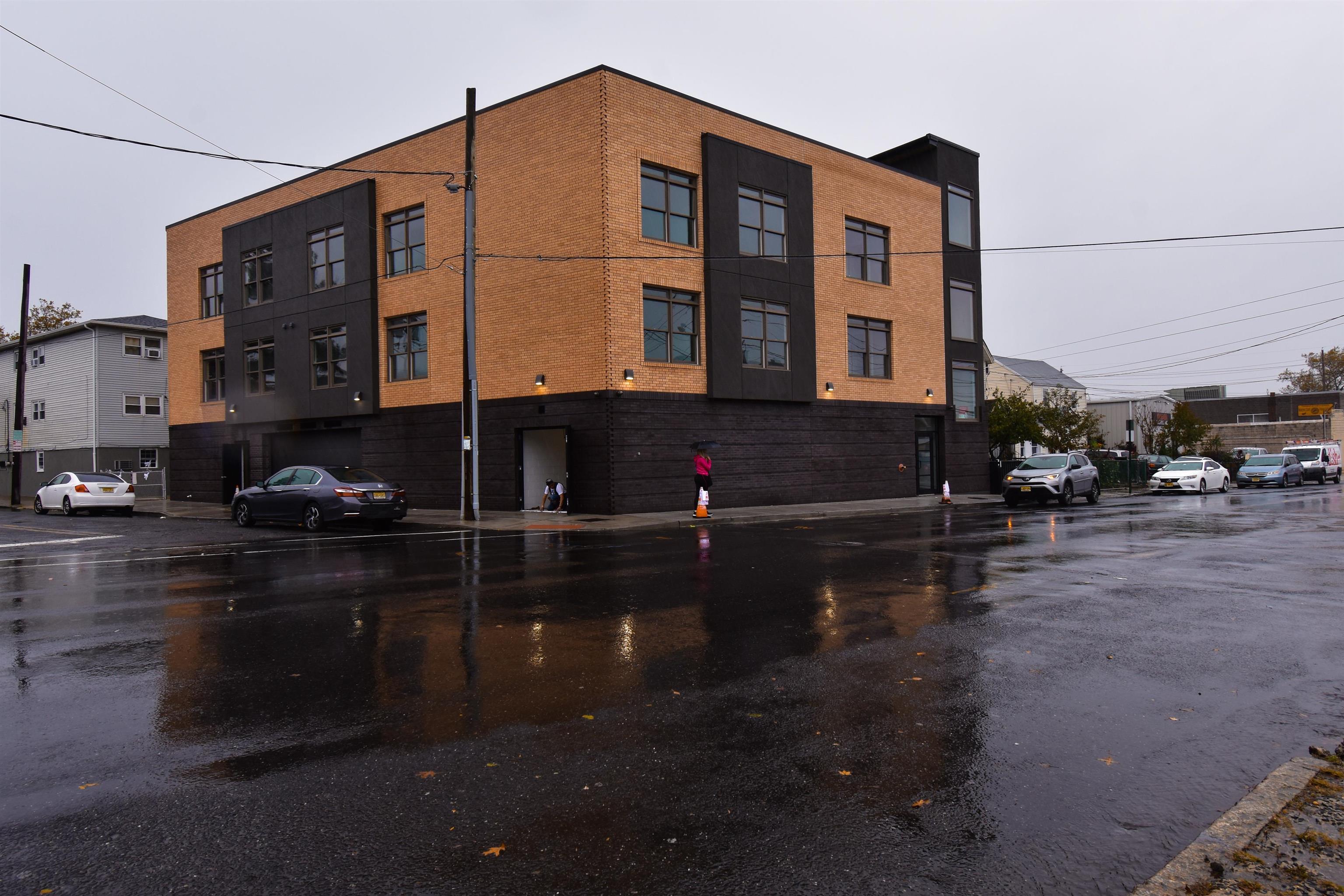 4201 Bergen Turnpike, Unit 2D North Bergen, NJ 07047 - Photo 12 of 12 a city street lined with buildings and cars parked on the road