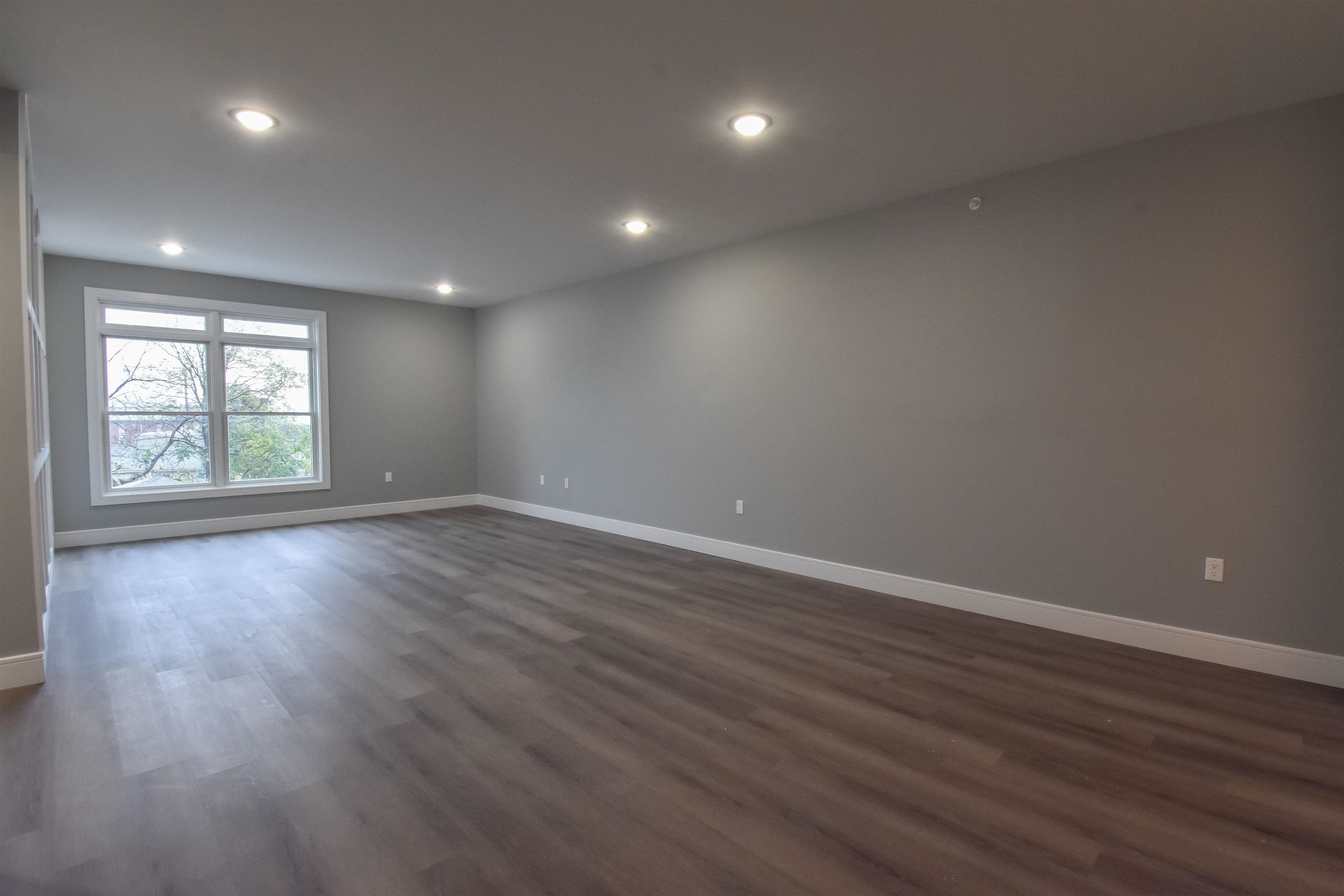 4201 Bergen Turnpike, Unit 2D North Bergen, NJ 07047 - Photo 2 of 12 an empty room with wooden floor and windows
