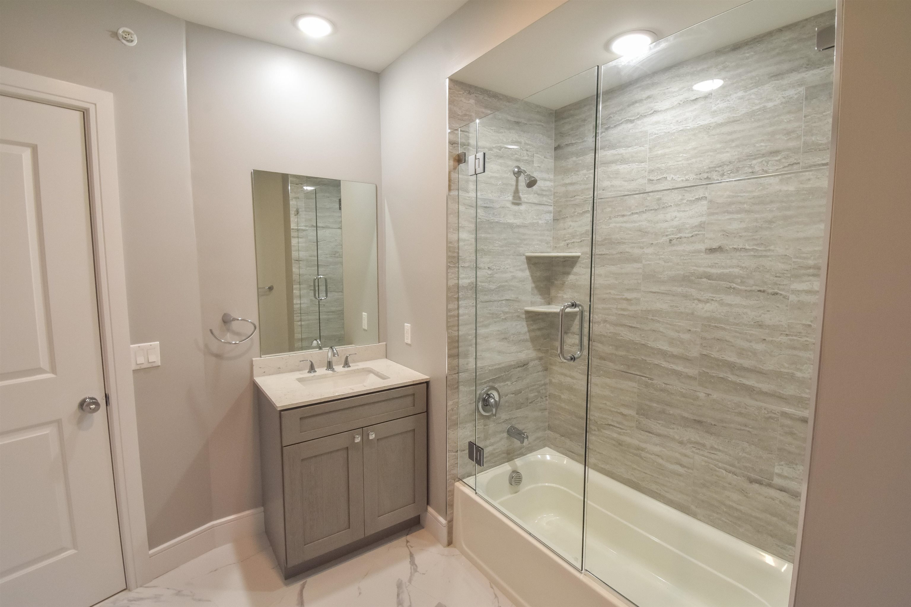 4201 Bergen Turnpike, Unit 2D North Bergen, NJ 07047 - Photo 8 of 12 a bathroom with a shower mirror and a sink