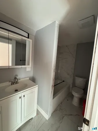 a bathroom with a sink toilet and tub