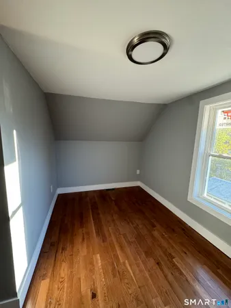 a view of a room with wooden floor and window