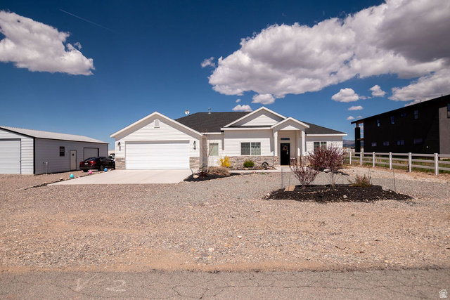 745 East 885 North Beaver, UT 84713 - Photo 1 of 50 Single story home with stone siding, concrete driveway, and an attached garage