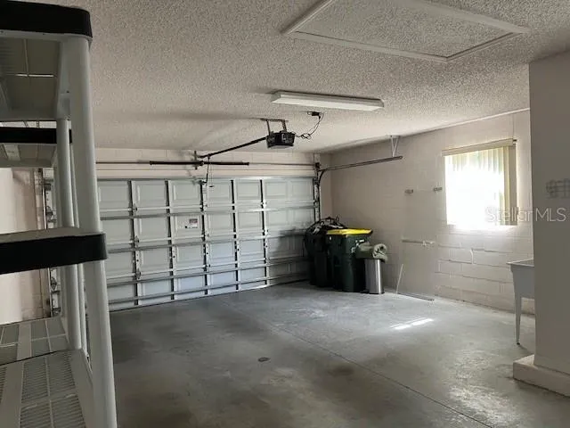 a view of an empty room with a window and a fan