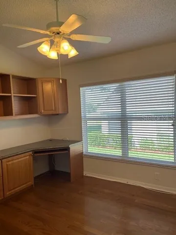 an empty room with a window and chandelier