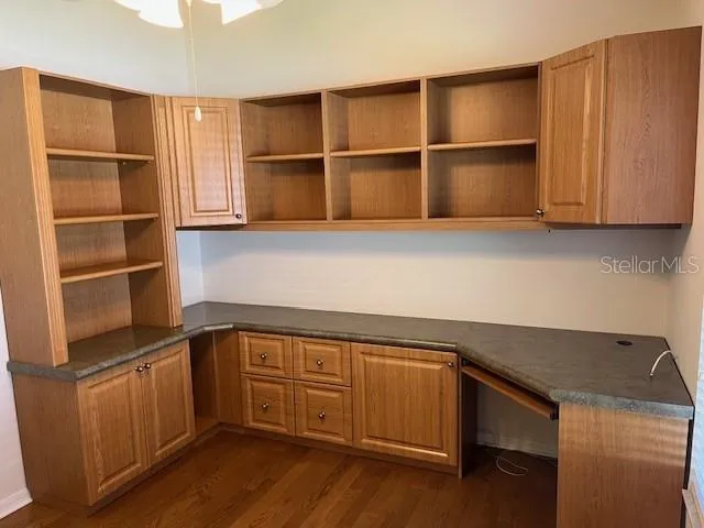 a kitchen with a refrigerator and cabinets