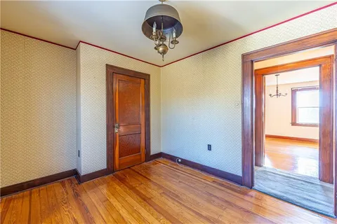 a view of room with window and wooden floor