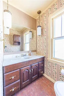 a spacious bathroom with a granite countertop bathtub sink vanity mirror and