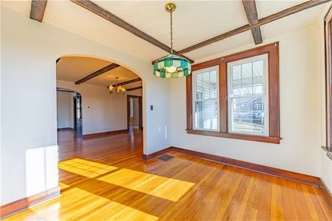 a view of a room with wooden floor and windows