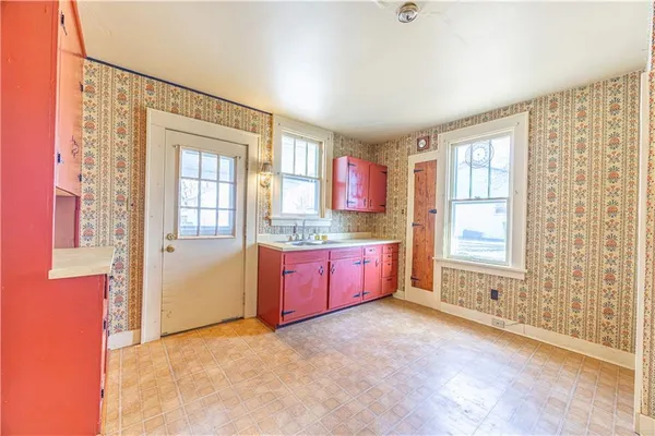 a open kitchen with granite countertop a refrigerator sink and cabinets