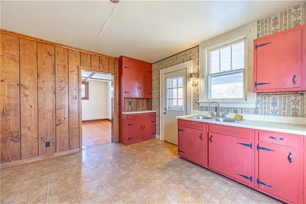a large kitchen with kitchen island granite countertop a large window