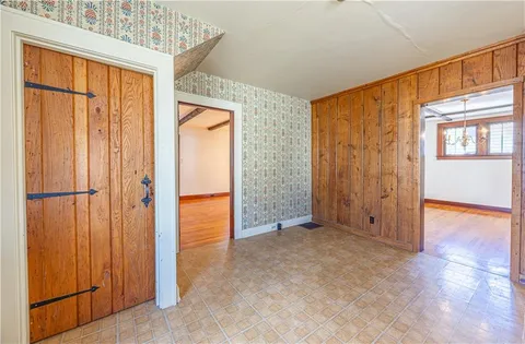 an empty room with closet and wooden floor