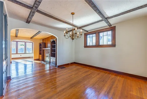 a view of a room with wooden floor chandelier and entryway