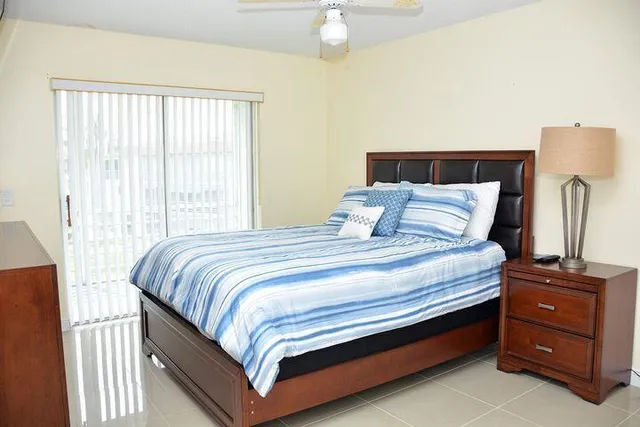 a bedroom with a bed and a night stand