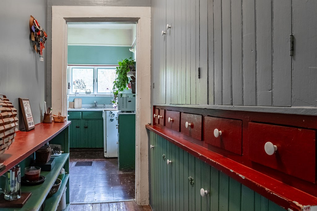 67 Fisk Road Bovina, NY 13753 - Photo 13 of 48 Vintage built-in cabinetry lines the hallway leading directly into the kitchen beyond, the perfect pass thru pantry