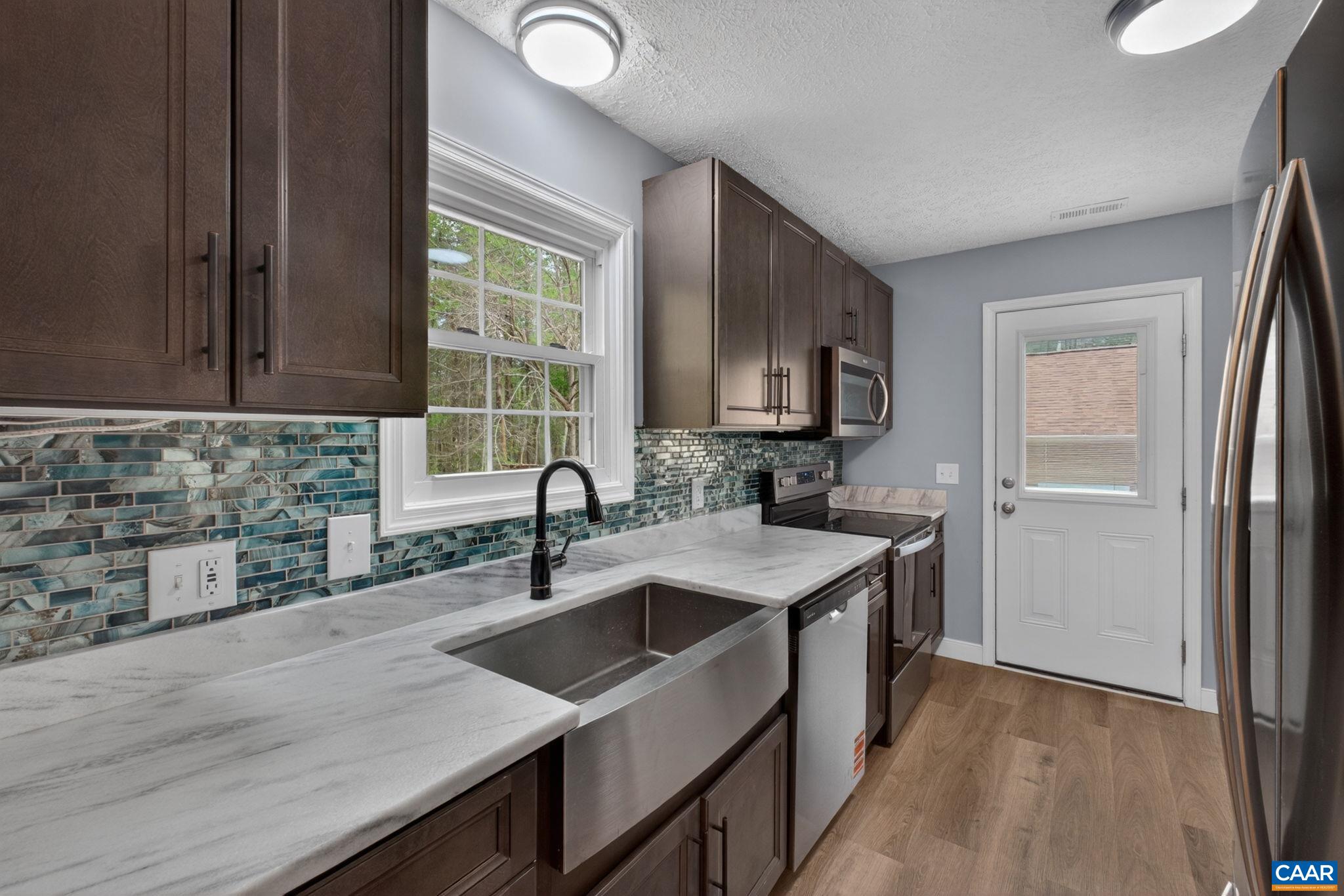 673 Cedar Lane Road Palmyra, VA 22963 - Photo 13 of 47 a kitchen with a sink stove top oven and refrigerator