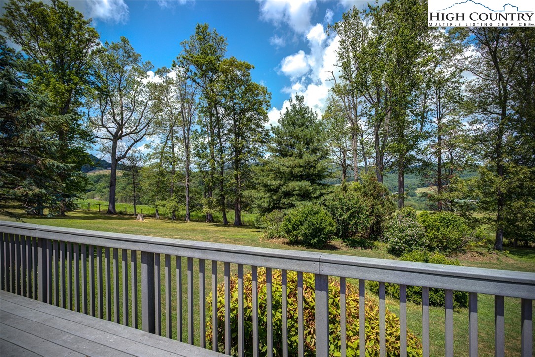 356 Irwin Farm Lane Sparta, NC 28675 - Photo 16 of 50 a balcony with trees in front of it