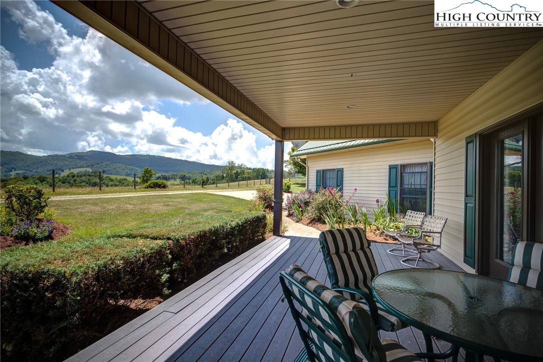 356 Irwin Farm Lane Sparta, NC 28675 - Photo 20 of 50 a view of a dining room with furniture swimming pool and outdoor seating