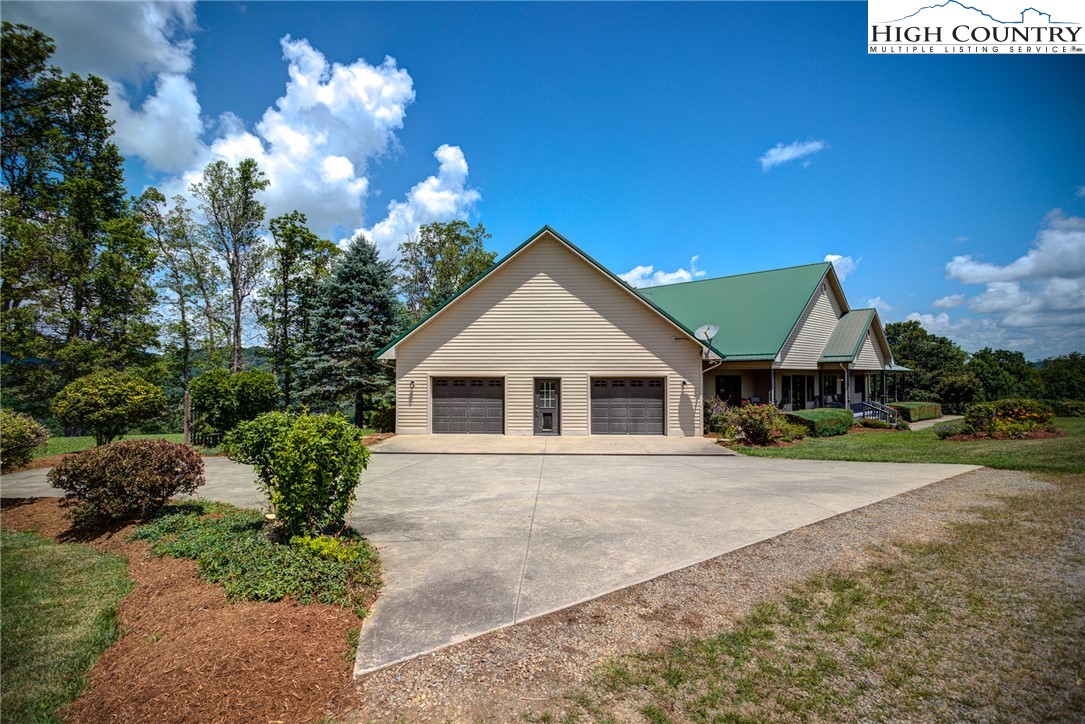 356 Irwin Farm Lane Sparta, NC 28675 - Photo 2 of 50 a front view of a house with a yard and garage