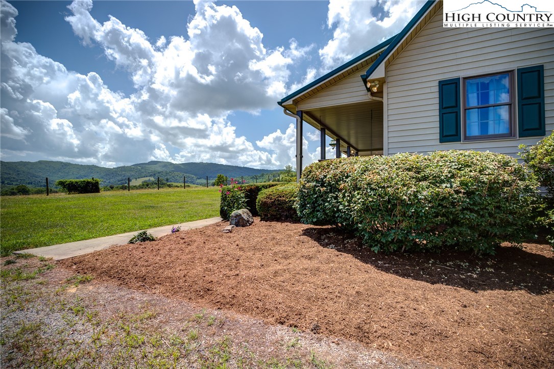 356 Irwin Farm Lane Sparta, NC 28675 - Photo 21 of 50 a front view of a house with garden
