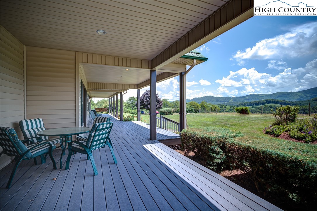 356 Irwin Farm Lane Sparta, NC 28675 - Photo 22 of 50 a view of a porch with furniture and garden
