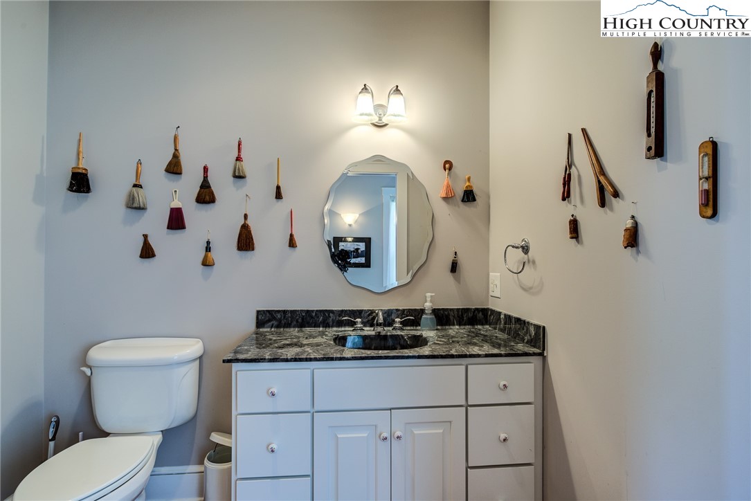 356 Irwin Farm Lane Sparta, NC 28675 - Photo 37 of 50 a bathroom with a toilet sink and mirror