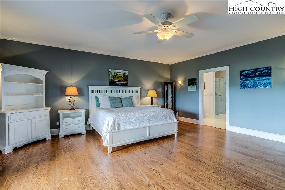356 Irwin Farm Lane Sparta, NC 28675 - Photo 38 of 50 a bedroom with a bed chandelier and a window