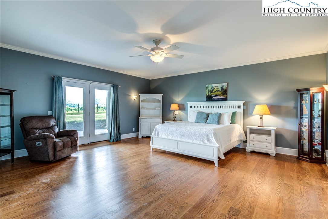 356 Irwin Farm Lane Sparta, NC 28675 - Photo 40 of 50 a bedroom with a bed and wooden floor