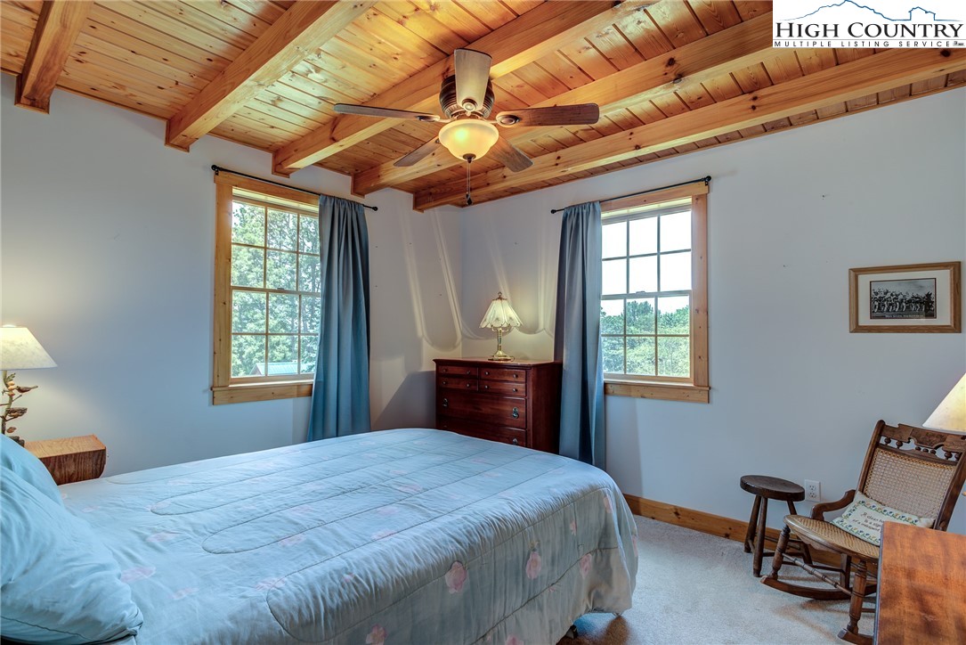 356 Irwin Farm Lane Sparta, NC 28675 - Photo 45 of 50 a bedroom with a bed next to a window