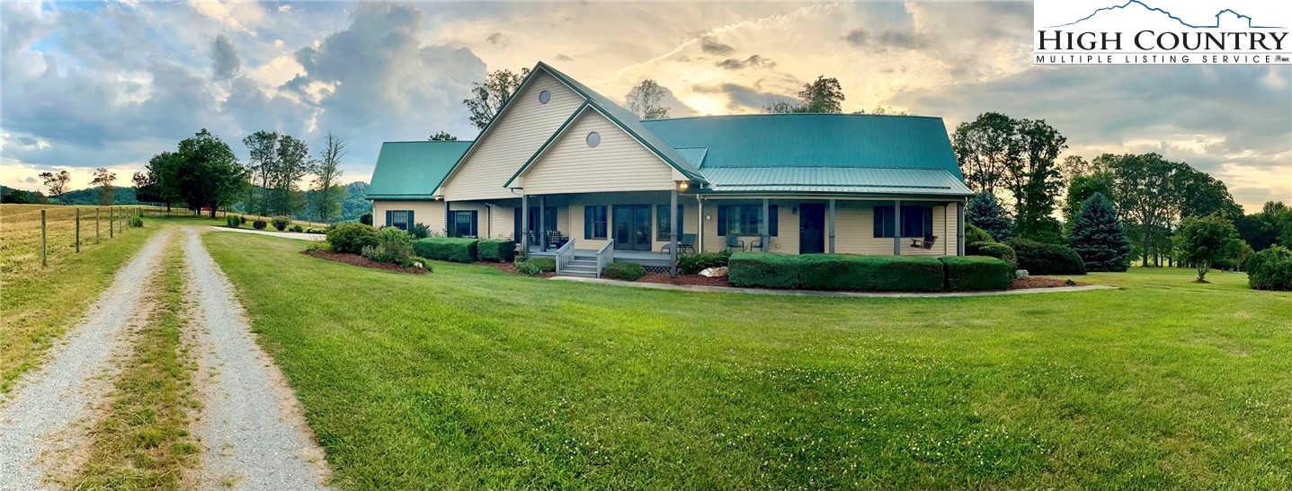 356 Irwin Farm Lane Sparta, NC 28675 - Photo 50 of 50 a view of house with garden and tall trees