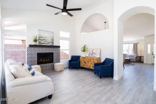 a living room with furniture and a fireplace