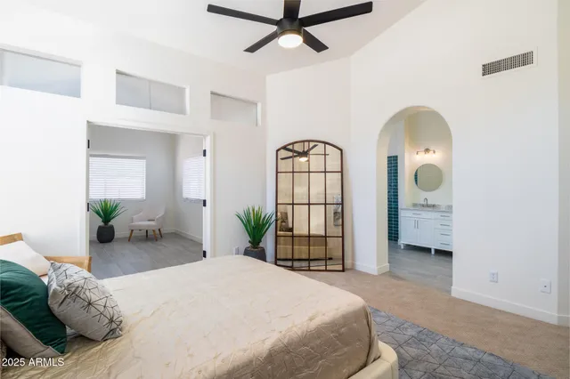 a bedroom with a bed and a chandelier