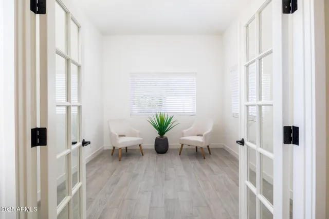 a living room with furniture windows and wooden floor