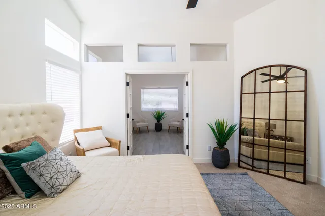 a bedroom with furniture and a potted plant