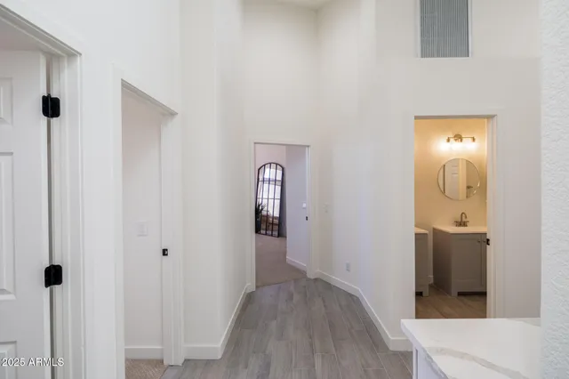 a view of a hallway with wooden floor and closet area