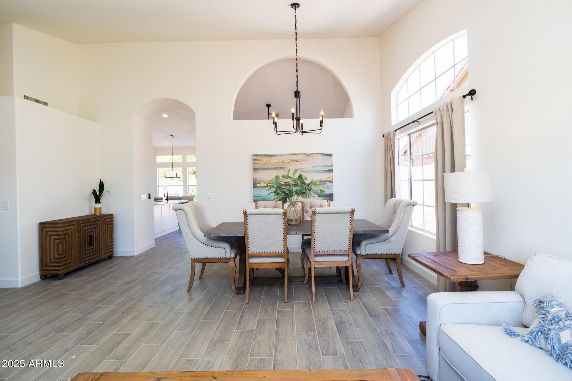 850 North Los Altos Drive Chandler, AZ 85224 - Photo 6 of 34 a dining room with wooden floor a chandelier a wooden table and chairs