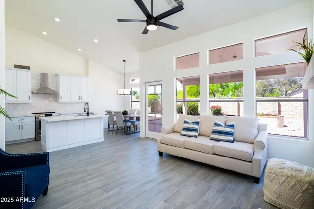 a living room with furniture and large windows