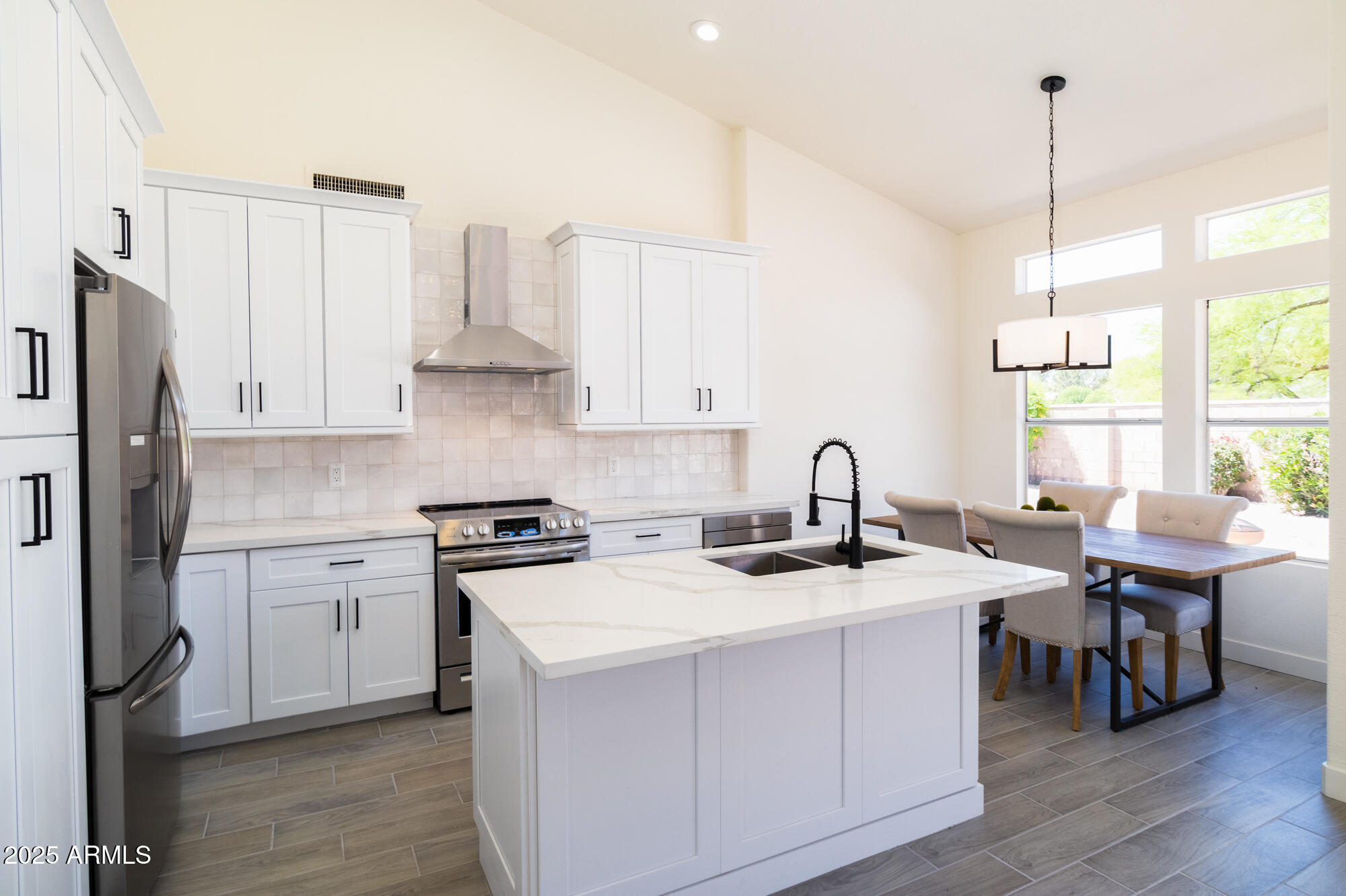 850 North Los Altos Drive Chandler, AZ 85224 - Photo 8 of 34 a kitchen with stainless steel appliances granite countertop a stove a sink dishwasher and a refrigerator with wooden floor