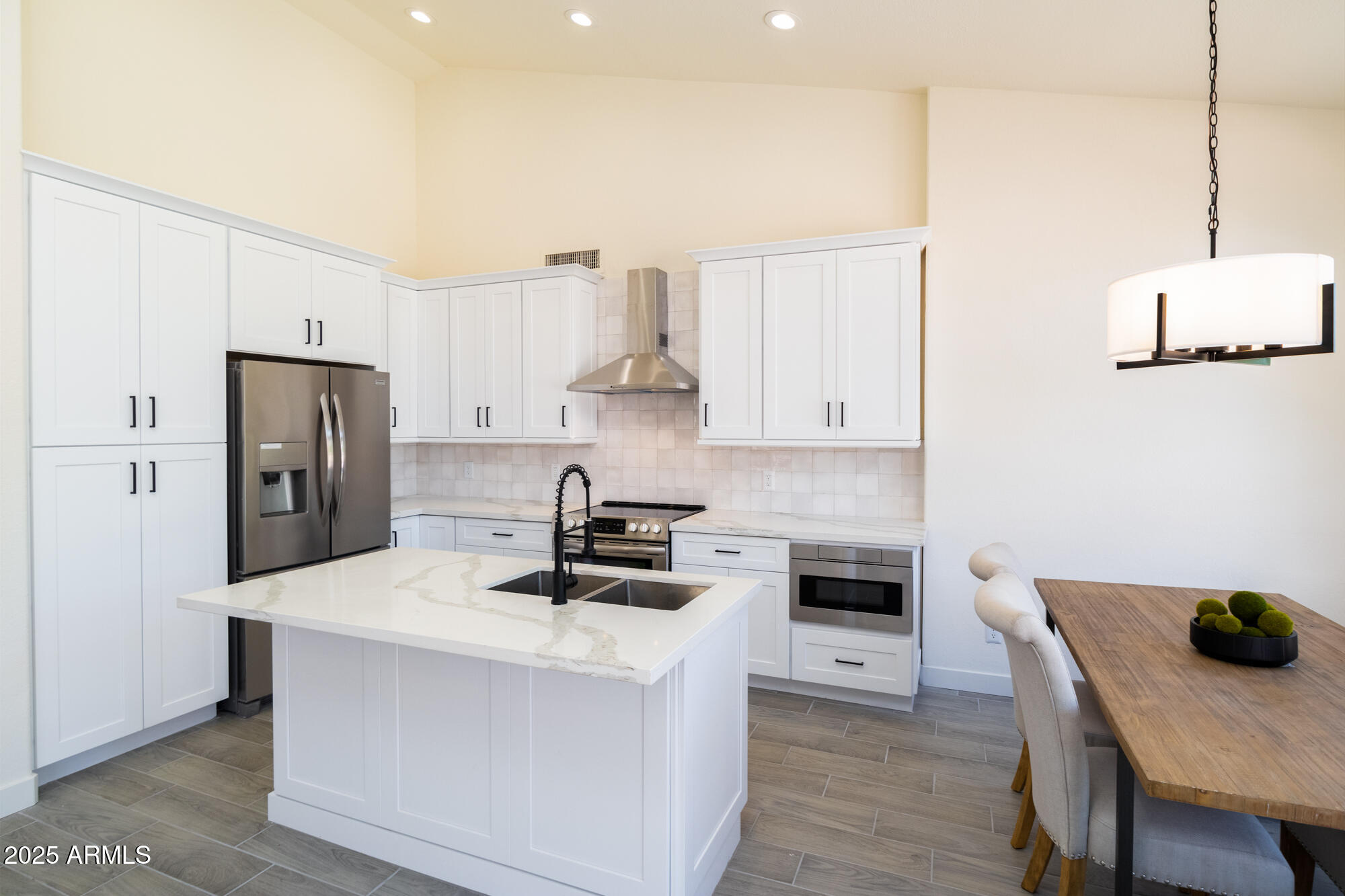 850 North Los Altos Drive Chandler, AZ 85224 - Photo 10 of 34 a kitchen with stainless steel appliances a stove a refrigerator a sink a stove and white cabinets
