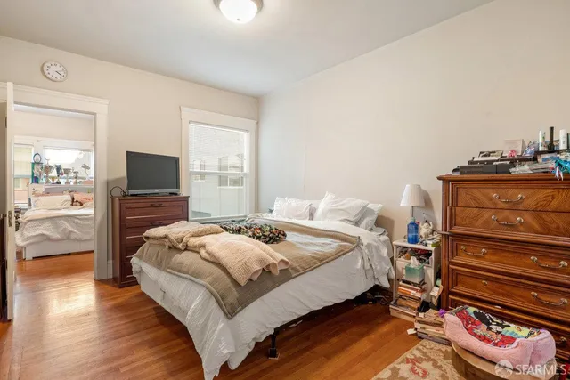 a bedroom with a bed and a television