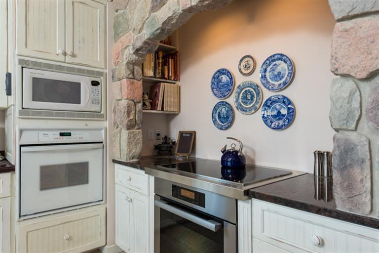113 James Circle Mashpee, MA 02649 - Photo 11 of 21 a kitchen with a stove and cabinets